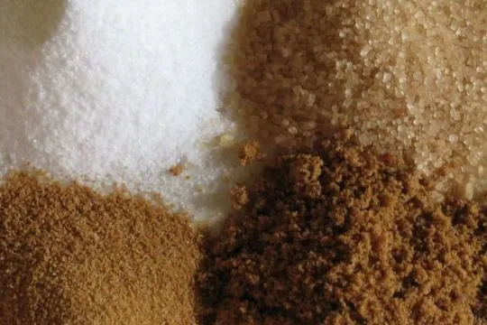 White, brown and whole cane sugars side by side